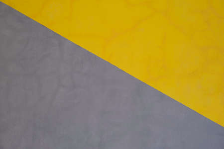 Yellow and gray geometric design painted on cement wall in Bali, Indonesiaの写真素材