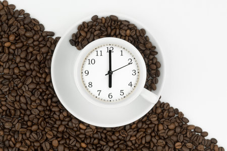 Alarm clock in a cup of coffee. Photo creative. Confluence Cup of fresh espresso with clock sign, top view. Space for textの写真素材