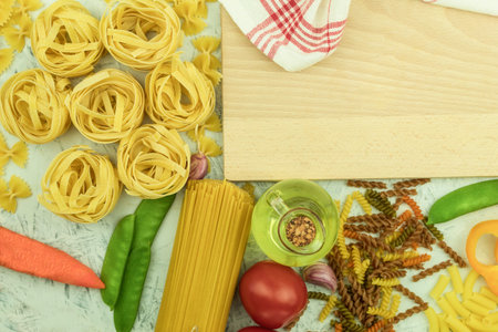Assorted different types of pasta on the table. Various types of raw pasta and noodles with...