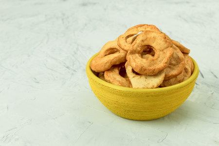 Fresh apples and dried apples on the table. Background with copy space. Artistic food concept on kitchen countertopの写真素材