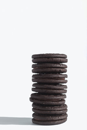 Sweet and dark cookies on a white isolated background. Sweet cookies with chocolate filling on a white background. Space for textの写真素材
