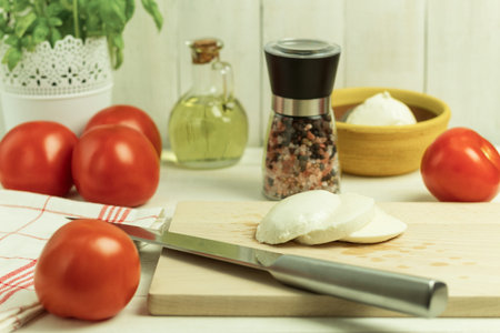 Fresh tomato and mozzarella on a wooden background. Caprese salad. copy space