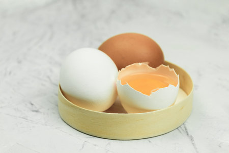 Fresh and raw chicken egg in flour. Bright color of egg yolk and wheat flour. Ingredients for baking...
