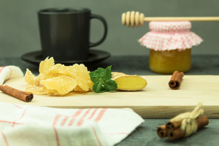 Three kinds of ginger - ground spice fresh and candied on rustic table. Healthy eating, home remedy for nausea upset stomach colds.の写真素材