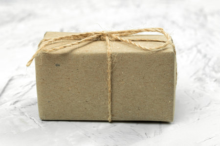 The box is wrapped with rope, the parcel is on a rustic background. Chrome key. copy space. Brown...