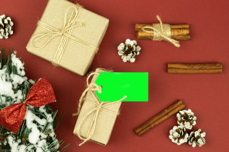 Tag on a box with a gift, tied with a rope. Paper parcel wrapped with a price tag on a wooden background. Chrome key. copy spaceの写真素材