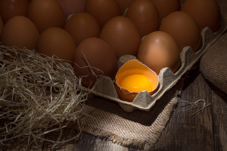 Freshly picked chicken eggs on a rustic background. Chicken eggs in hay, rural scene