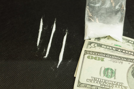 White powder is scattered on the table. White powder is scattered on the glass table next to the...