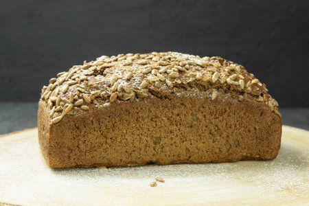 Fresh dark bread. Rye bread on the board. Whole grain rye bread with seeds. Healthy Eating. Copy...