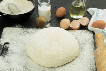 Freshly made dough on the table. A ball of dough for baking. Background with copy space