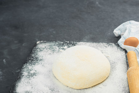 Freshly made dough on the table. A ball of dough for baking. Background with copy spaceの写真素材