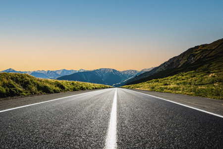 A road in a mountainous area. Beautiful mountain landscape. View of the highway in the mountainous area. Beautiful road background. Road landscape in beautiful nature. Sunset, sunriseの素材