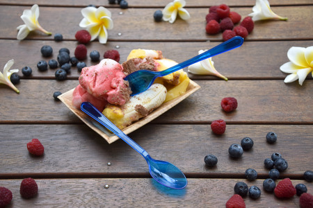 Ice Cream in Palm Leaf Plate with Blue Spoonの写真素材