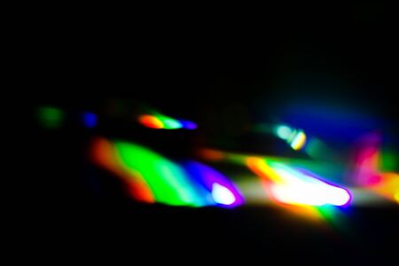 Rainbow light Reflected on blackの写真素材