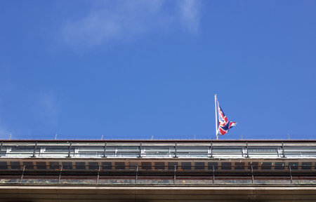 Blue sky with copy space with Union Jack flag above building