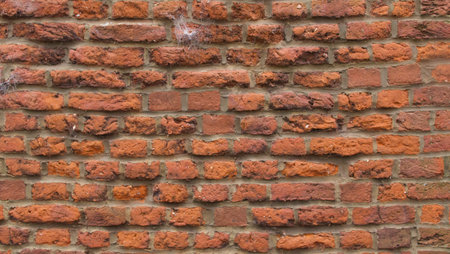 Rustic old red brick wall background with grey mortar between bricks