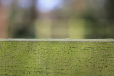 Full frame countryside background with green wooden bar in foregroundの写真素材