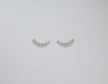 Two false eyelashes against plain white background with copy spaceの写真素材