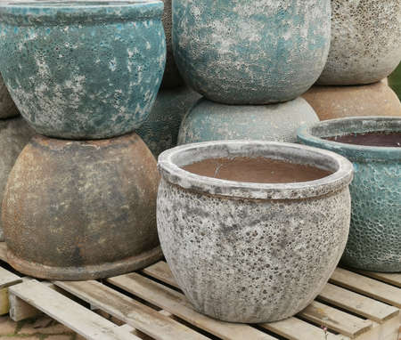 Close up of assorted earthenware pots stacked on wooden palletsの写真素材