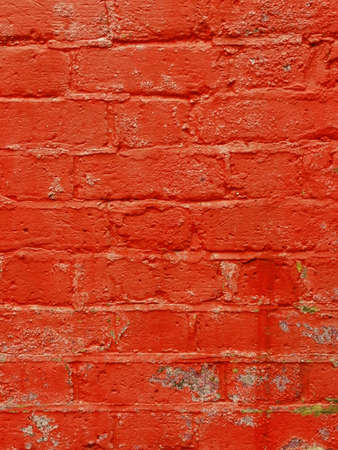 Vertical weathered painted coarse red brick background with copy spaceの写真素材