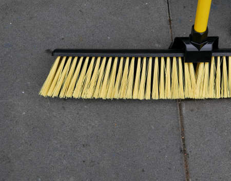 Yard broom with yellow bristles and handle with copy spaceの写真素材