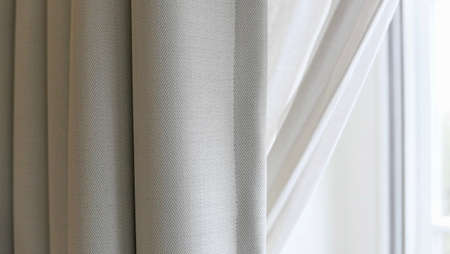 Pale grey curtain beside window with white space for copyの写真素材