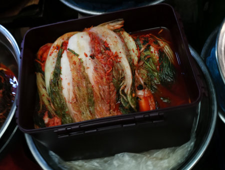 Plastic pot of kimchi on display for sale in South Korean street marketの写真素材