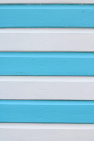Blue and white striped panelled wood with peeling paint and space for copyの写真素材