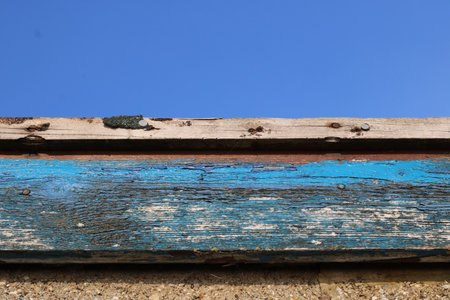 Close up of peeling white and blue paint on side of building roofの写真素材