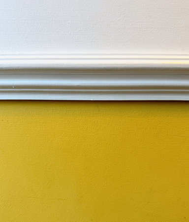 Interior image of white dado rail with yellow below and white aboveの写真素材