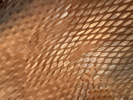 Full frame image of scrunched manilla coloured honeycomb packaging paperの写真素材