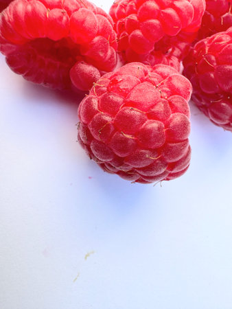 Close up of raspberries on white background with copy spaceの写真素材