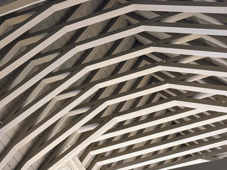 View looking upwards of painted wooden ceiling with rafters
