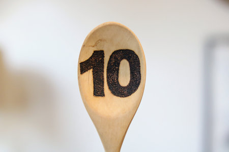 Wooden spoon bearing the number ten painted in black with copy spaceの写真素材