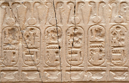 The Egyptian hieroglyphs on a wall of an ancient temple