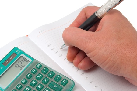 The calculator, organizer and the pen isolated on a white backgroundの写真素材