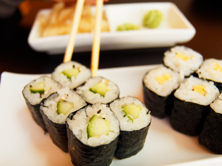 Kappa Maki being picked up with chopsticks.の写真素材