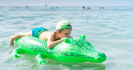 Portrait smiling little baby boy playing in the sea, ocean. Positive human emotions, feelings, joy....