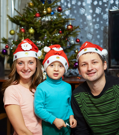 Happy family having fun with Christmas presents at homeの写真素材