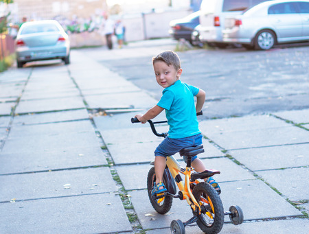 Funny active little boy riding on bicycle on warm summer day. Countryside. Active leisure andの写真素材