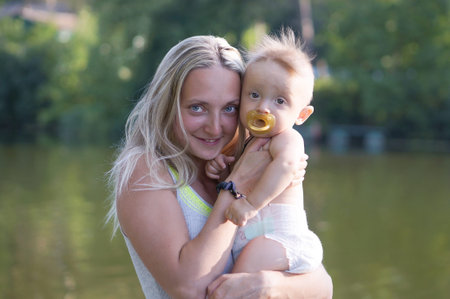 Mother with a little baby boy at the parkの写真素材