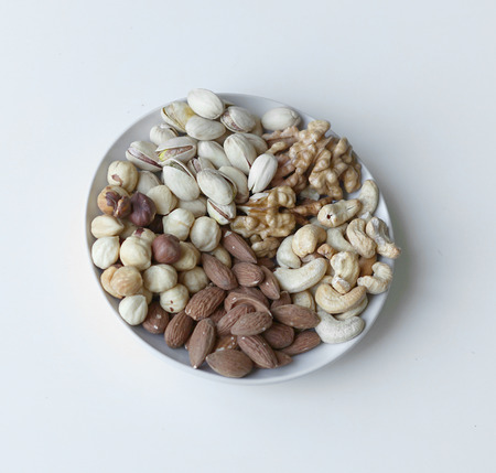 Healthy food. Nuts mix assortment on stone table top view. Collection of different legumes for background image close up nuts, pistachios, almond, cashew nuts, peanut, walnut. imageの写真素材