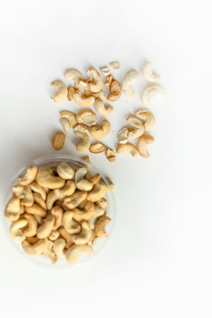 Healthy food  for background image close up cashew nuts.  Nuts texture on white grey table top view on the cup plateの写真素材