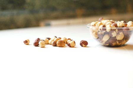 Healthy food  for background image close up hazelnuts.  Nuts texture on white grey table top view on the cup plateの写真素材