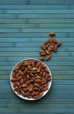 Healthy food  for background image close up almond nuts. Texture Nuts on the cup plateの写真素材
