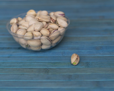 Healthy food  for background image close up pistachios nuts. Texture on top view Nuts pistachio on the cup plateの写真素材