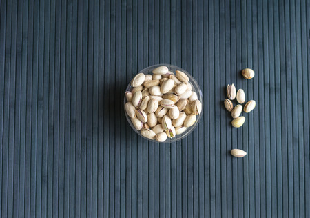 Healthy food  for background image close up pistachios nuts. Texture on top view Nuts pistachio on the cup plateの写真素材