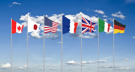 Silk waving G7 flags of countries of Group of Seven Canada, Germany, Italy, France, Japan, USA states, United Kingdom. Blue sky background.の写真素材