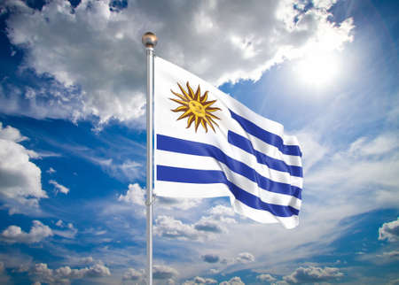 Realistic flag. 3D illustration. Colored waving flag of Uruguay on sunny blue sky background.の写真素材