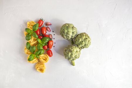Raw ingredients for cooking traditional Italian pasta with green artichoke. Top view, flat lay.の写真素材